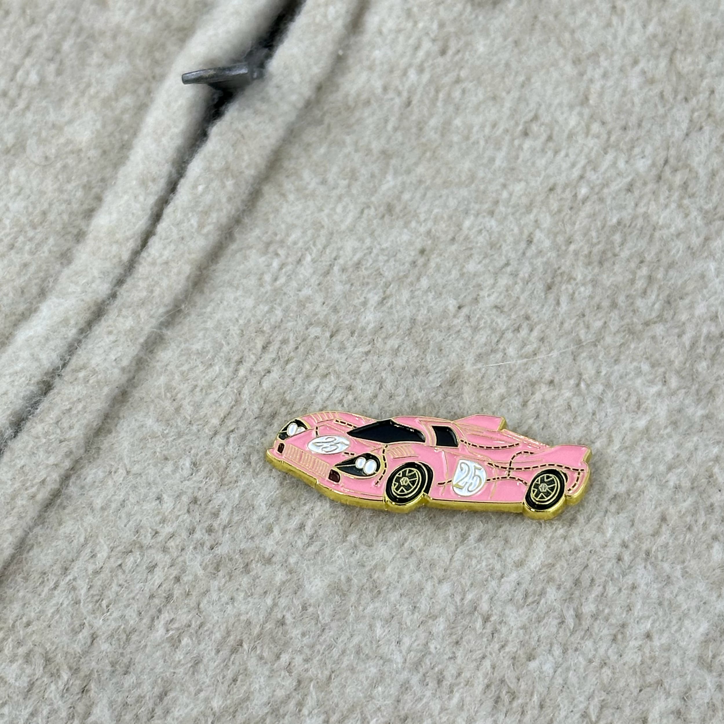 rennbetrieb porsche 917 pink pig enamel pin on beige pullover