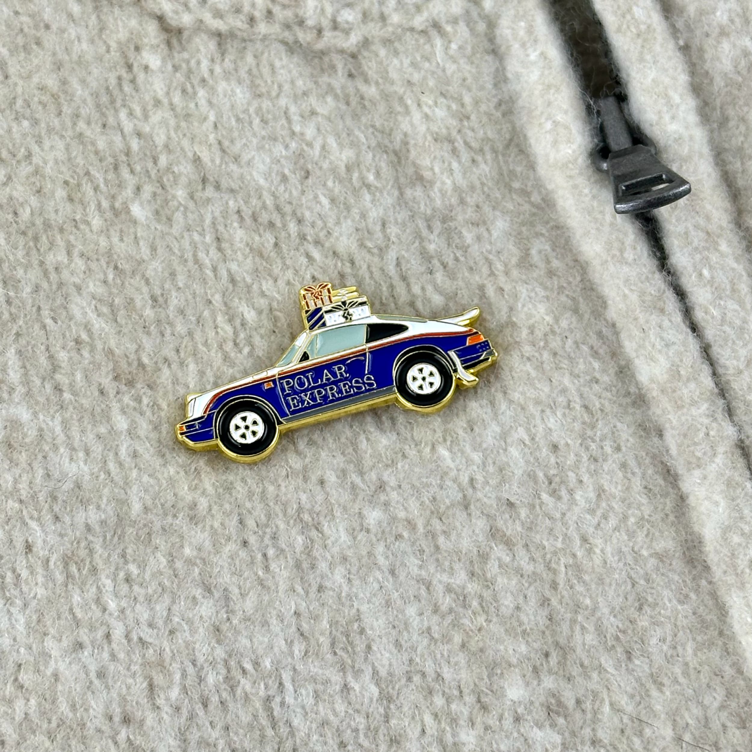 rennbetrieb porsche 953 polar express christmas enamel pin on beige pullover