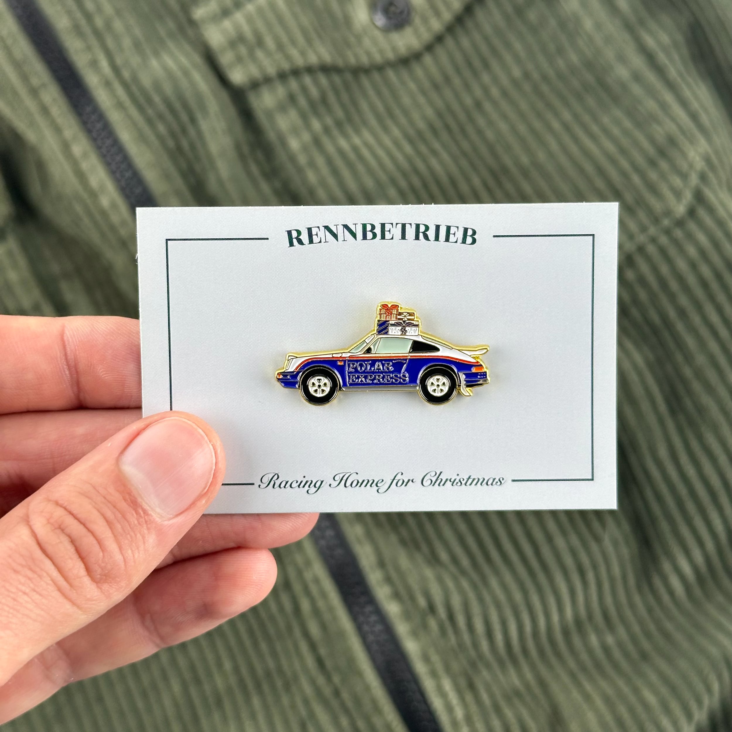 rennbetrieb porsche 953 polar express christmas enamel pin on beige pullover