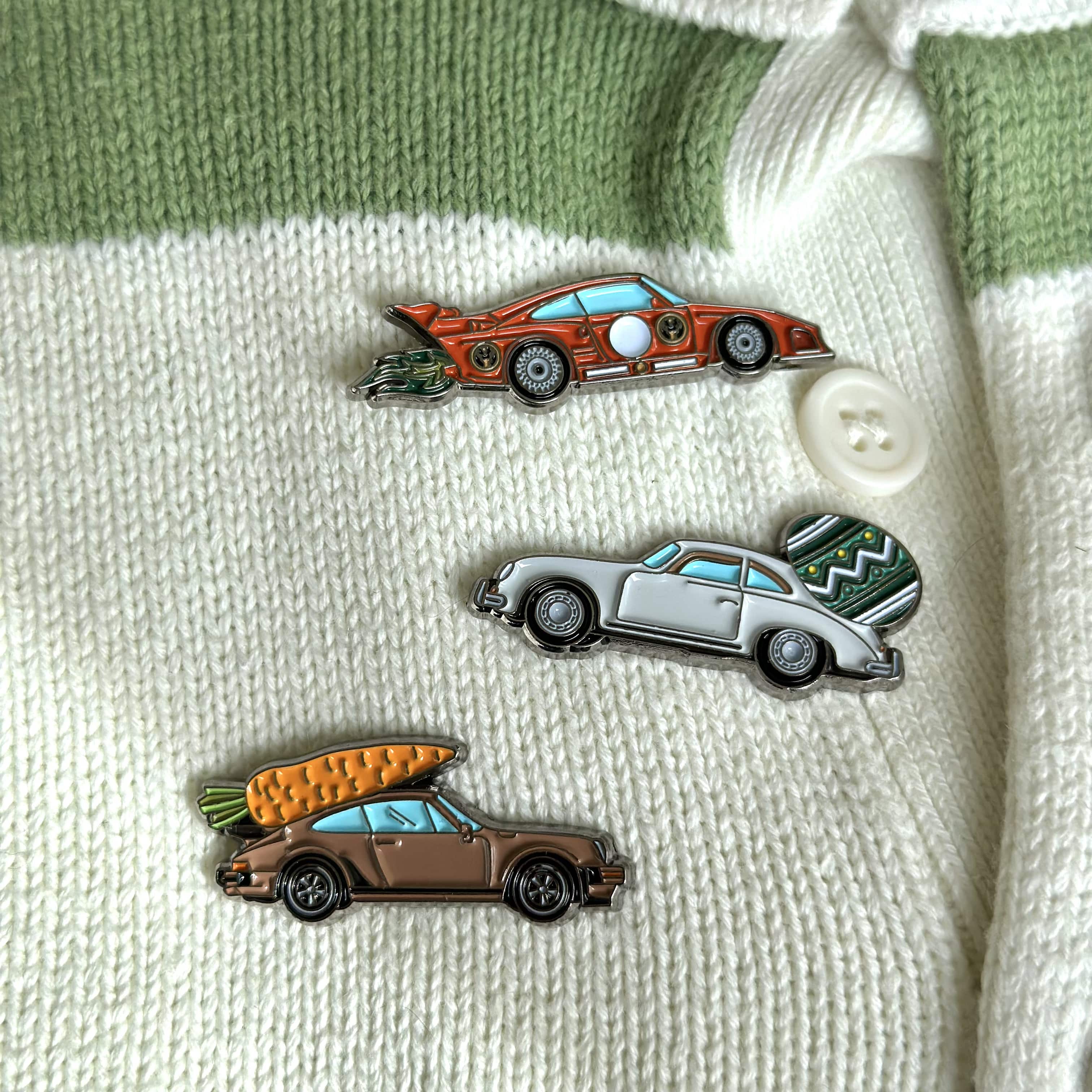 porsche easter pin set on green and beige sweatshirt