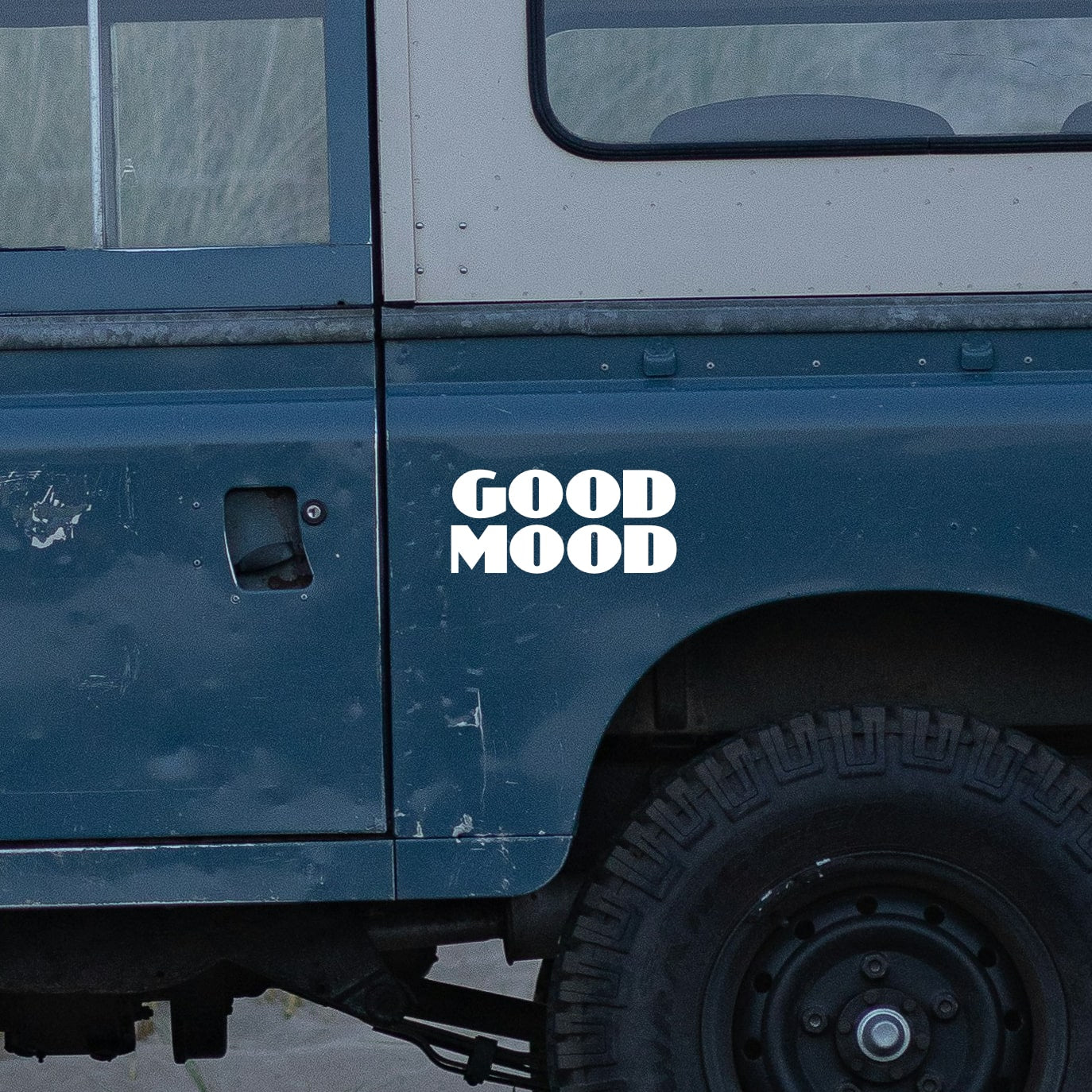 good mood sticker on blue land rover defender