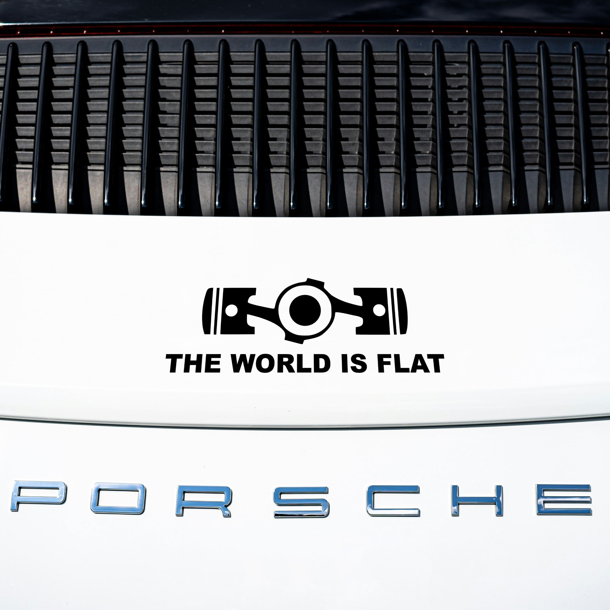 the world is flat sticker on white porsche 911